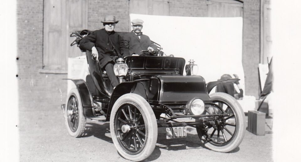Thomas Edison sitting in an early electric automobile